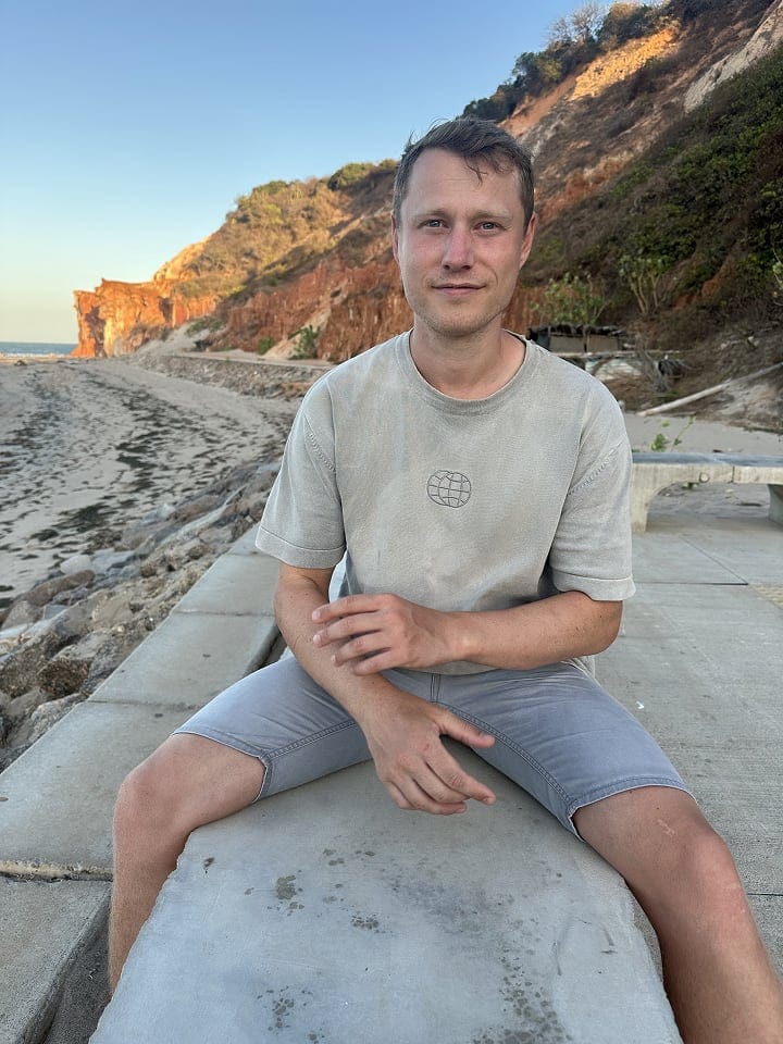 James profile image on a beach.